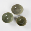 A set of three Chinese Ming dynasty celadon-glazed bowls