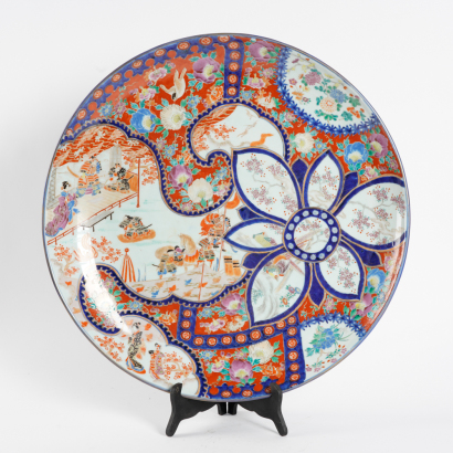 A large Japanese Meiji period dish with figures from Iwanari and flowers (Arita official kiln)