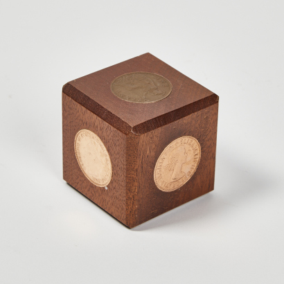 A Mahogany Five Penny Paperweight