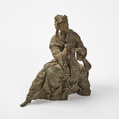 An Antique Spelter Statue Of A Seated Woman