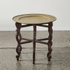 A Wood Base Coffee Table with a Round Brass Style Top