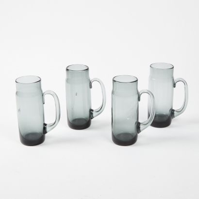 A Collection Of Holmegaard Style Smoked Glass Beer Mugs