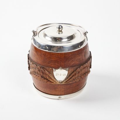 An Oak Carved Ice Bucket with Porcelain Interior and Silver Plated Lid