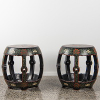 A pair of Chinese black lacquer and gilt flower motif drum stools