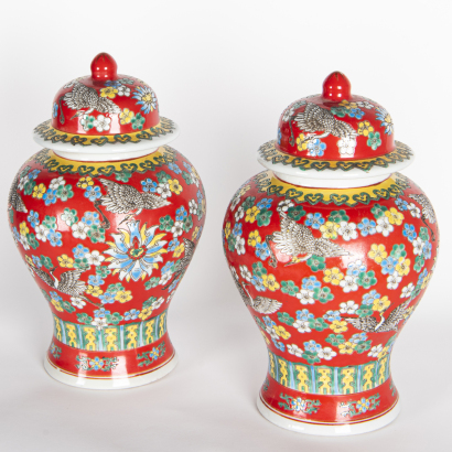 A pair of Chinese red-ground famille-rose 'floral' covered jars