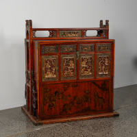 A Chinese Qing Dynasty gilt-decorated red-lacquer wedding chest with carved figures