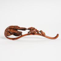 A Chinese Qing dynasty boxwood carved frog ruyi scepter