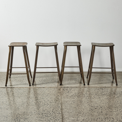 A Suite Of Four Industrial Metal Barstools