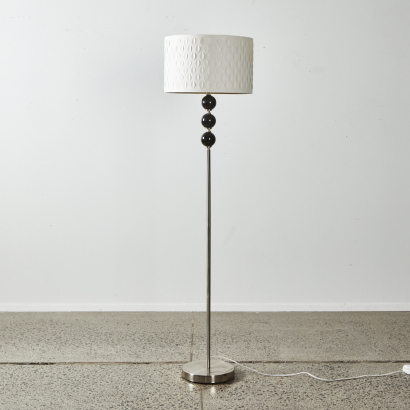 A Contemporary Floor Standing Lamp with Stainless Base & Decorative Shade