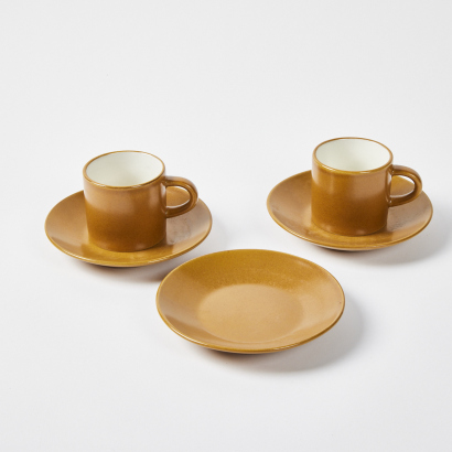 A Pair Of Coffee Cans With Three Saucers