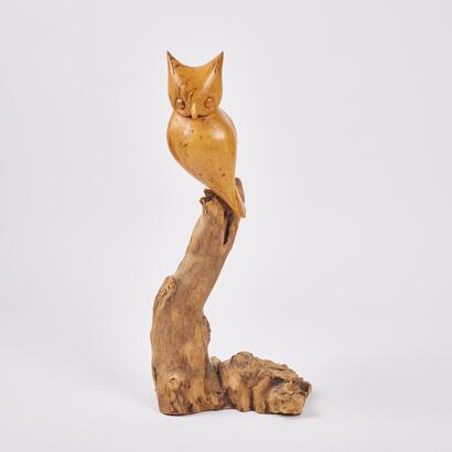A Carved Owl Figure With Driftwood Base