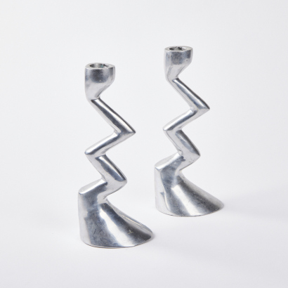 A Pair of Aluminium Candle Holders in the Style of Matthew Hilton