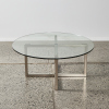 A Modern Circular Coffee Table With Glass Top & Stainless Base