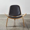 A Hans Wegner Style Shell Chair In Oak & Black Upholstery