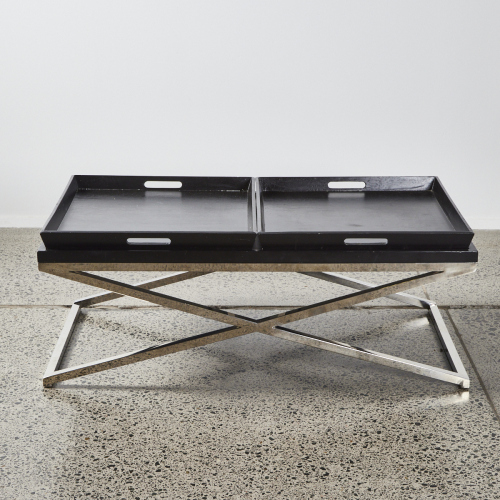 A Black Coffee Table With Chrome Cross Base