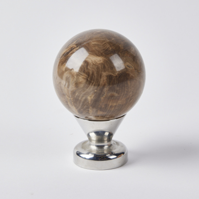 A Polished Stone Sphere With Stand