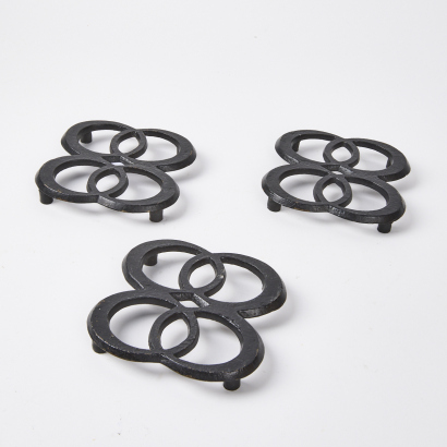 A Trio Of Cast Iron Hot Plate Stands