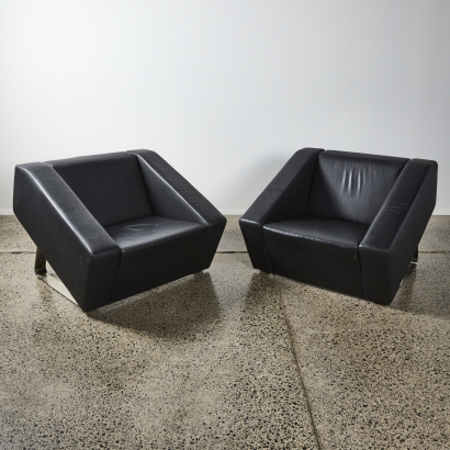 A Pair Of Black Leather Tub Chairs