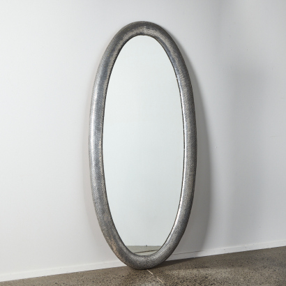 A Large Contemporary Oval Mirror With Metallic Frame