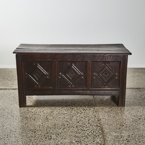 A Coffer With Three Panels Carved Front With A Diamond Shape To Each