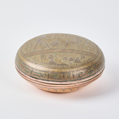 A Copper Container With Egyptian Details