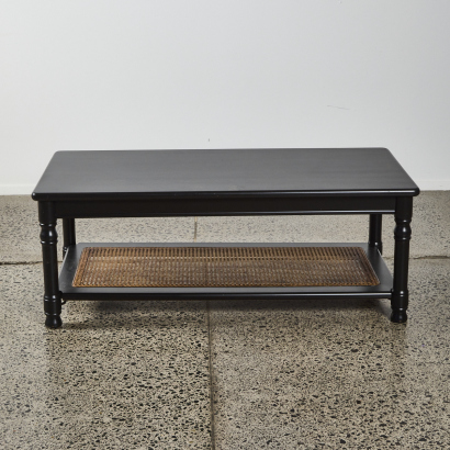 A Large Coffee Table With A Rattan Shelf