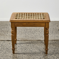 An Oak Stool With A Stitched Leather Seat