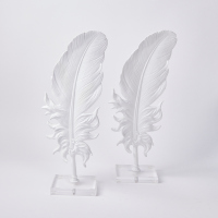 A Pair Of Cast Feathers On Lucite Base