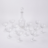 An Intricate Etched Glass Decanter & A Collection Of Cut Glass Champagne Coupes