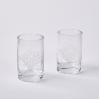 A Pair Of India Hicks Coral Etched Glass Candle Holders