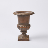 A Rustic Cast Iron Urn