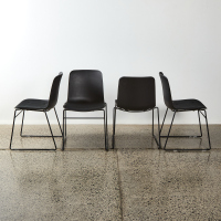 A Suite Of Four Minimal Black Sled Base Chairs