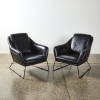 A Pair of Structured Leather Armchairs in the style of Carlo de Carli