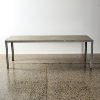 A Large Outdoor Table With Metal Legs & Concrete Top