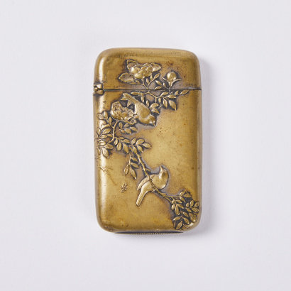 A late 19C-early 20C brass 'flower and bird' match safe, Japan