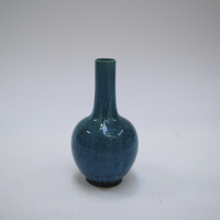 A Chinese Qing Dynasty peacock blue glazed vase