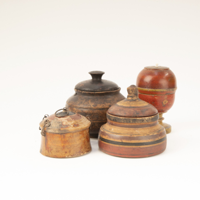 A group of four old wooden jars from Afghanistan