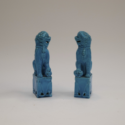 A pair of Chinese sky-blue glazed lion ornaments