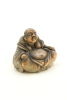 A Japanese 20th century porcelain small seated buddha (minor damaged)