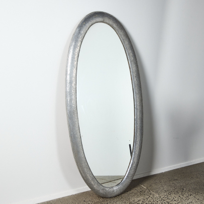 A Large Contemporary Oval Mirror With Metallic Frame