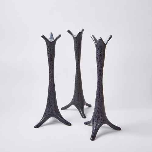 A Set Of Three Sculptural Biomorphic Cast Aluminium Candleholders