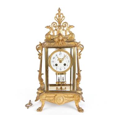 A 19th Century French Ornate Ormolu and Glass Panelled Striking Mantel Clock