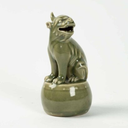 A Chinese celadon glaze beast ornament