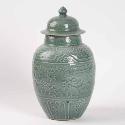 A Chinese Qing Dynasty celadon glazed 'dragon' covered Jar