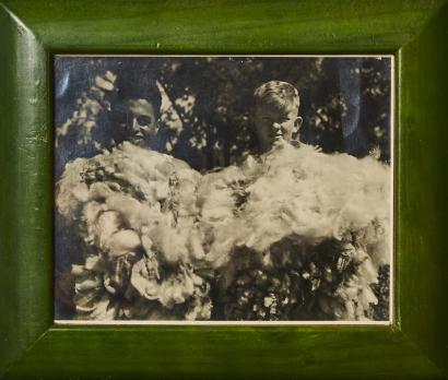 A Green Framed Photo of Boys Sorting Wool