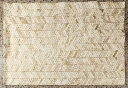 A Faux Cowhide Paneled Rug