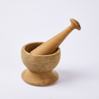A Wooden Mortar And Pestle Set