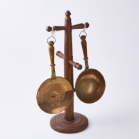 A Pair Of Copper Utensils on A Wooden Stand