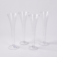 A Set Of Four Etched Crystal Champagne Flutes