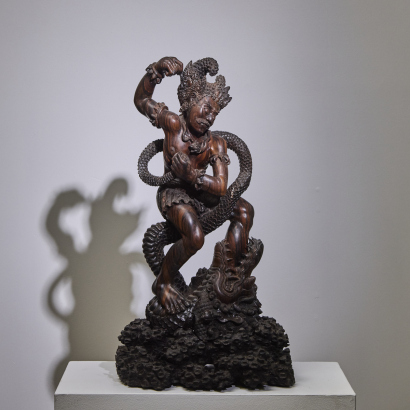 A Hardwood Carving of a Indonesian Deity Battling a Serpent